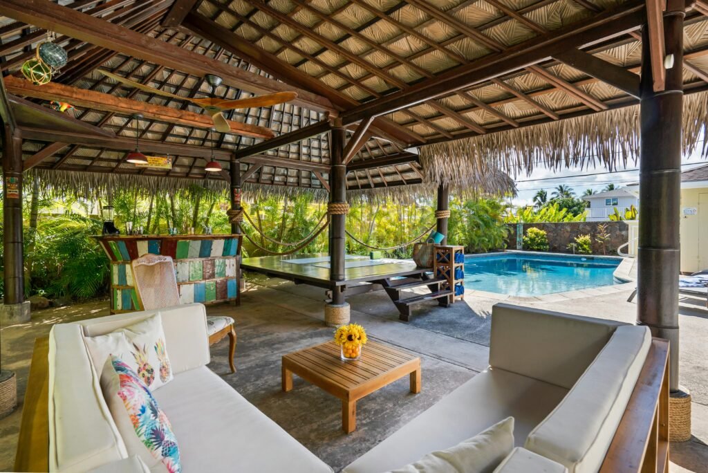 pexels photo 3209049 3209049 Tropical outdoor patio featuring a cabana, seating area, and swimming pool, perfect for luxury relaxation.